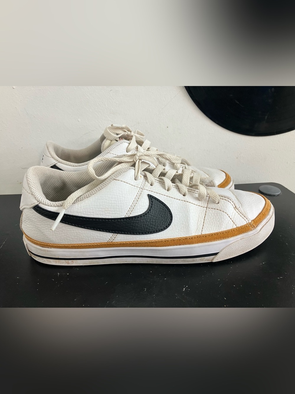 Nike White Low-Top Sneakers with Black Swoosh and Tan Accent